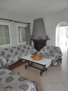 a living room with a couch and a table at Korina house in Tragasiá