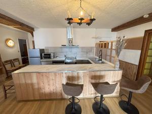 a kitchen with a large island in the middle at Le Villard appartement Adrech in Abriès