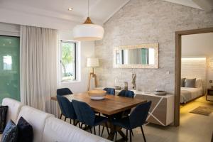 a dining room and living room with a table and chairs at Comfortable villa with private pool in Grand-Baie