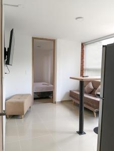 a living room with a table and a couch at Denier House II in Ibagué
