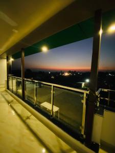 a balcony with a view of the city at night at DE AERO SUITES Near Dehradun Airport in Rāni Pokhri