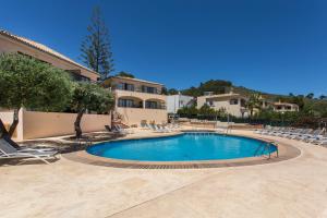 a swimming pool in a resort with lounge chairs at Mar Hotels Alcanada in Port d'Alcudia
