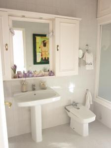 a white bathroom with a sink and a toilet at Villa Jordana Urbapol One Step To The Beach in San Pol de Mar +39 photos