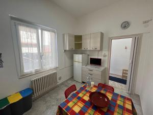 a small kitchen with a table and a refrigerator at Giulialidohome in Giulianova
