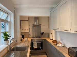 a kitchen with a sink and a stove top oven at Smile 'N' Wave in Gorleston-on-Sea
