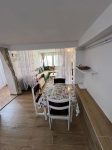 a living room with a table and a couch at Apartments Obradović Milan in Žabljak