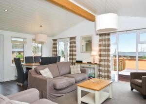 a living room with a couch and a table at Cheddar Woods Resort And Spa in Cheddar