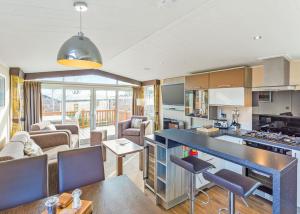 a kitchen and living room with a table and chairs at Cheddar Woods Resort And Spa in Cheddar