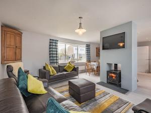 a living room with a couch and a fireplace at Little Dab in Brancaster