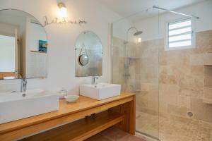a bathroom with a sink and a shower at Villa Célestine in Saint-Paul