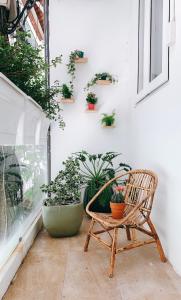 a chair sitting on a porch with potted plants at Vevy House - Homestay in Town in Danang
