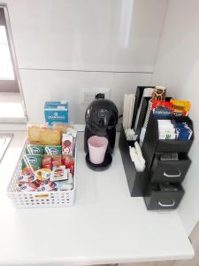 a kitchen counter with snacks and a coffee maker at Modestina's house in Mondragone +2 photos