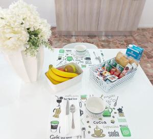 a table with a bunch of food and a vase of flowers at Modestina's house in Mondragone