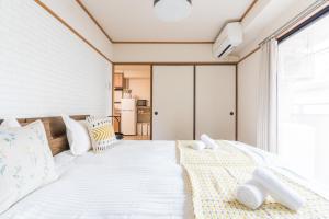 Llit o llits en una habitació de perfect life緑橋