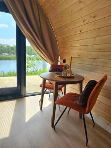 a sauna with a table and chairs in a room at Tiny House De Houtekster in Westergeest +16 photos