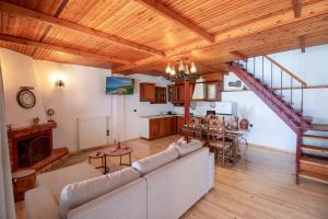 a living room with a couch and a table at Stamos Paradise View in Zagora