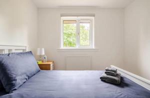 a bedroom with a bed with two towels on it at Little france house room1 in Edinburgh