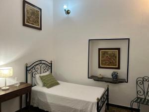 una camera da letto con un letto, un tavolo e uno specchio di Casa dos Avós a Campinho