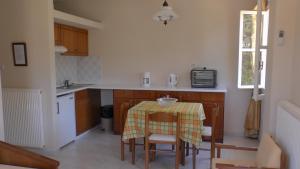 a kitchen with a table with a table cloth on it at Captain's Apartments in Kiónion