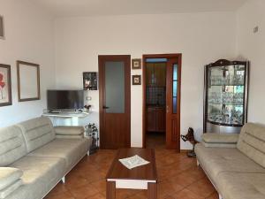 a living room with two couches and a table at Seid Apartments Radhime in Vlorë