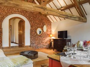 a living room with a table with wine glasses at The Barn in Nantwich