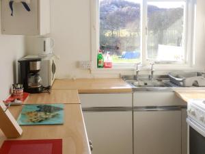 a kitchen with a sink and a window at Loch Ness - Uk7094 in Contin