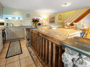 a kitchen with a large wooden counter in a room at Cherry Tree Cottage - Uk46659 in Cheddar