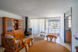 a living room with a wooden table and chairs at Torrebaix in Torredembarra