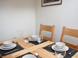 a wooden table with plates and wine glasses on it at Inglewood Terrace in Penrith +12 photos