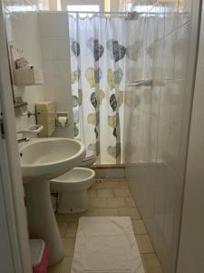 a bathroom with a sink and a toilet and a shower at Hotel Giglio in Lampedusa