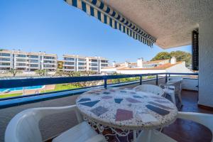 a table and chairs on a balcony with a view at Torrebaix in Torredembarra