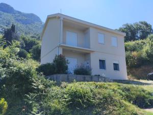 a white house on top of a hill at Adriatic Sunset House in Petrovac na Moru