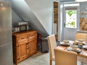 a kitchen with a table with a microwave on top of it at Beeswax Cottage in Dalton in Furness +20 photos