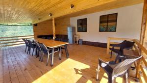 a dining room with a wooden table and chairs at Cabana 325 in Cinciş +18 photos