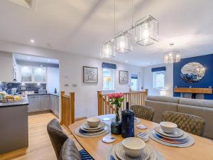 a dining room and kitchen with a table and chairs at Lindale Cottage in Skipton +14 photos