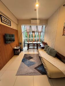 a living room with a couch and a table at Pico de Loro - Welki's Place in Nasugbu