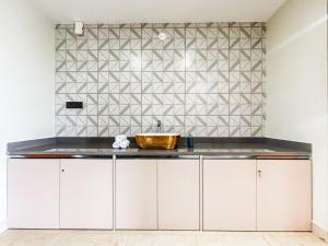 a kitchen with white cabinets and a sink at 5 Star Luxe 2BHK River View Apartment Porvorim in Porvorim +49 photos