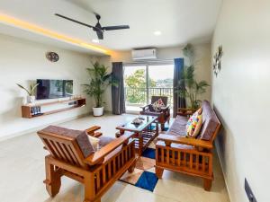 a living room filled with furniture and a flat screen tv at 5 Star Luxe 2BHK River View Apartment Porvorim in Porvorim