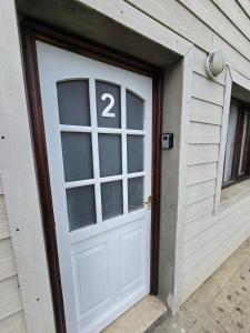 a white garage door with the number on it at Aparts Valentyna El Chalten 2 in El Chalten