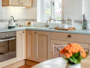 a kitchen with a sink and a counter at The Coach House in Aldington