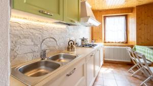 a kitchen with a sink and a stove at Casa Lateis 24 in Lateis