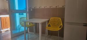 Una mesa pequeña y dos sillas en una habitación. en une chambre, un salon, cuisine et balcon, en Monastir 6 fotos más