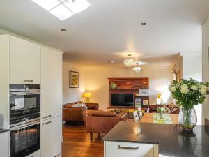 a living room with a couch and a table at Torrance At Abbey Park Avenue in St. Andrews