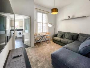 a living room with a couch and a table at Grosvenor Apartment in High Heaton