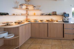 a kitchen with a counter with food on it at Prie Marių Nida in Nida +93 photos
