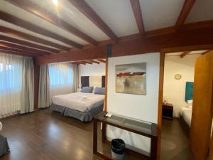 Postel nebo postele na pokoji v ubytování Hotel Lagoluz + 36 fotografií