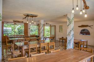 a dining room with a large table and chairs at Cabañas Armonía y Jardín de Orquídeas in Mindo