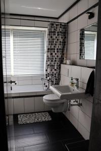 Un baño con lavabo, inodoro y bañera. en I&D Apartments, en Duisburg