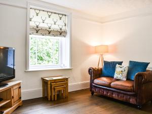 a living room with a couch and a window at Chapel Cottage in Robin Hood's Bay