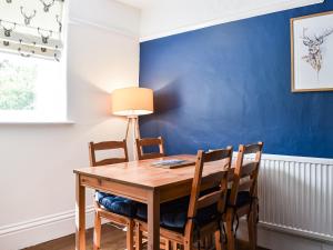 a dining room with a wooden table and chairs at Chapel Cottage in Robin Hood's Bay